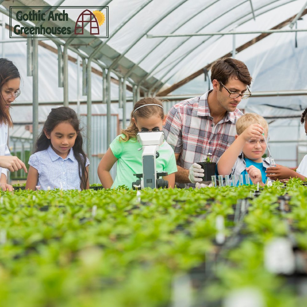Educator teaching students in a greenhouse setting